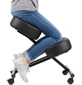 Person sitting on ergonomic kneeling chair.