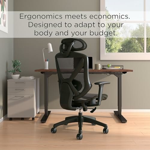 Ergonomic office chair in front of a desk with computer and lamp.