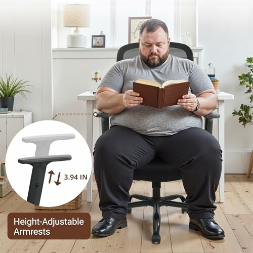 Man sitting on ergonomic office chair reading a book.