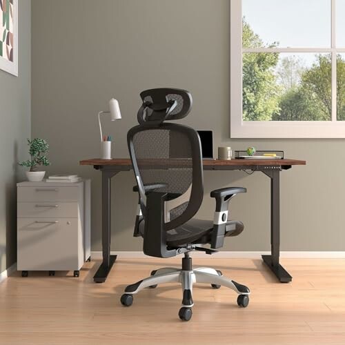 Modern home office with ergonomic chair, desk, and window view.